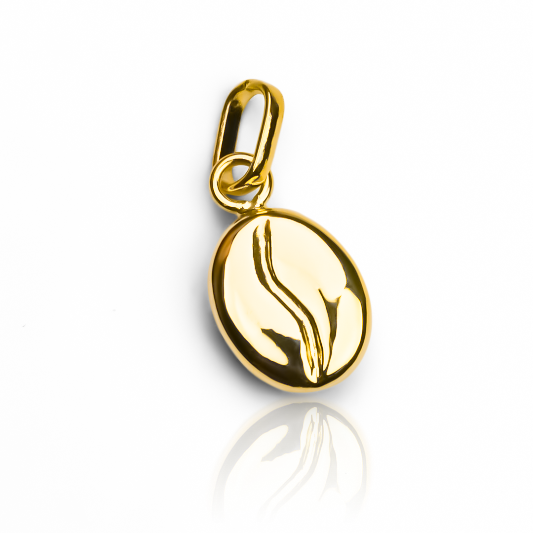 Elegante y exclusivo dije de grano de café en oro 18K de la reconocida joyería Caracas. Garantía de por vida para una joya de calidad premium. Eleva tu estilo con este símbolo de lujo y sofisticación. Perfecto para cualquier ocasión.