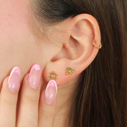 Oreja de mujer con topito en forma de barbie en oro amarillo de 18 quilates, hechos en Joyería Caracas. 