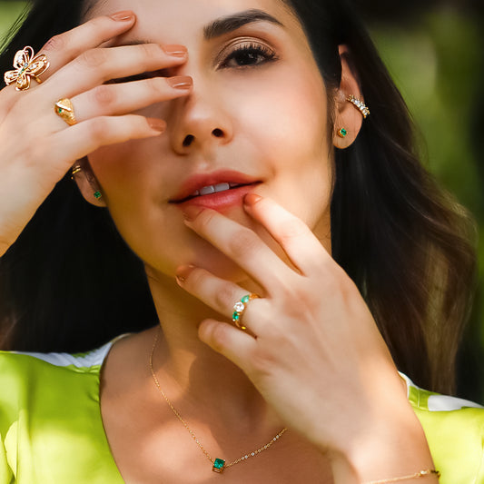 Oreja de mujer con topito en forma cuadrada en oro amarillo de 18 quilates con piedra preciosa de Esmeralda, hechos en Joyería Caracas. 