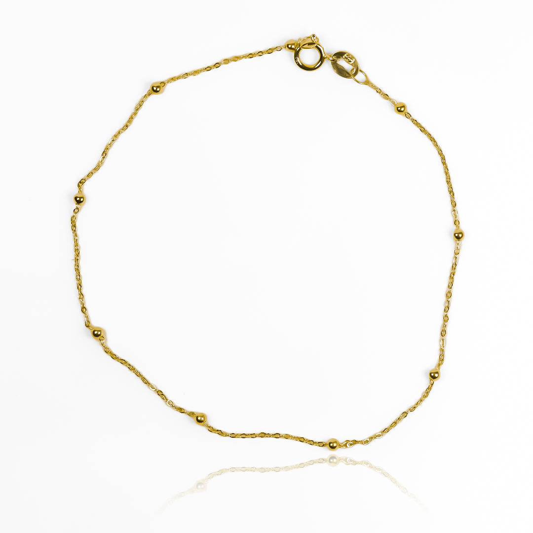 Lujo y elegancia se unen en nuestra Pulsera Esferas lisas I. Hecha de oro 18K por los expertos de Joyería Caracas, es el complemento perfecto para cualquier ocasión. Con garantía para toda la vida, esta pulsera es una inversión en calidad y estilo.