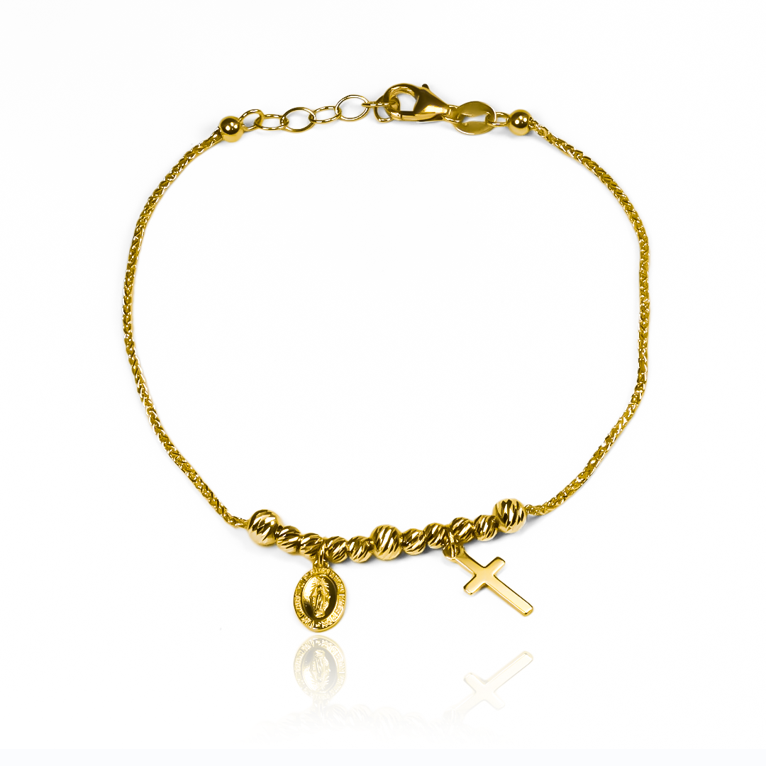 Luce esta exquisita y elegante Pulsera Guadalupe cruz I, diseñada con Oro 18K de la prestigiosa Joyería Caracas. Con su icónico diseño de la cruz, esta pulsera es una declaración de estilo y devoción. Además, cuenta con garantía para toda la vida, asegurando su durabilidad y calidad excepcional.