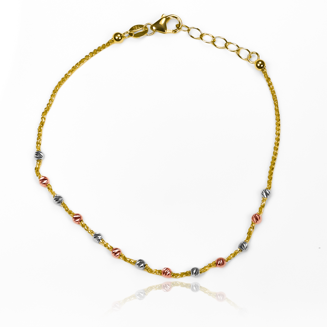 Descubre la elegancia y el lujo en la pulsera esferas diamantadas 3 oros I. Hecha con oro 18K de la exclusiva Joyería Caracas, esta pieza es una garantía para toda la vida. Una combinación perfecta de brillo y sofisticación.