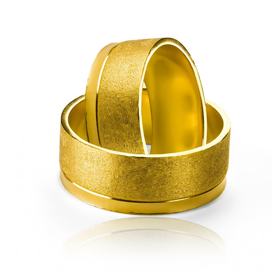 anillos de bodas de oro de 18k en Joyería Caracas! Este par de anillos presenta un diseño único y moderno con un acabado plano convexo que simboliza la unión inquebrantable de dos almas. Cada anillo está grabado con el sello de calidad y certificado de autenticidad