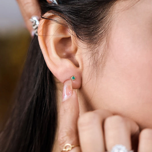 Oreja con topito en forma de cuadrado en oro amarillo de 18k con esmeralda hecho en Joyería Caracas. 