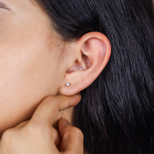 Oreja de mujer con topito circular en oro amarillo de 18 quilates y cristal de color blanco #3 con 6 uñas, hecho en joyeria caracas.